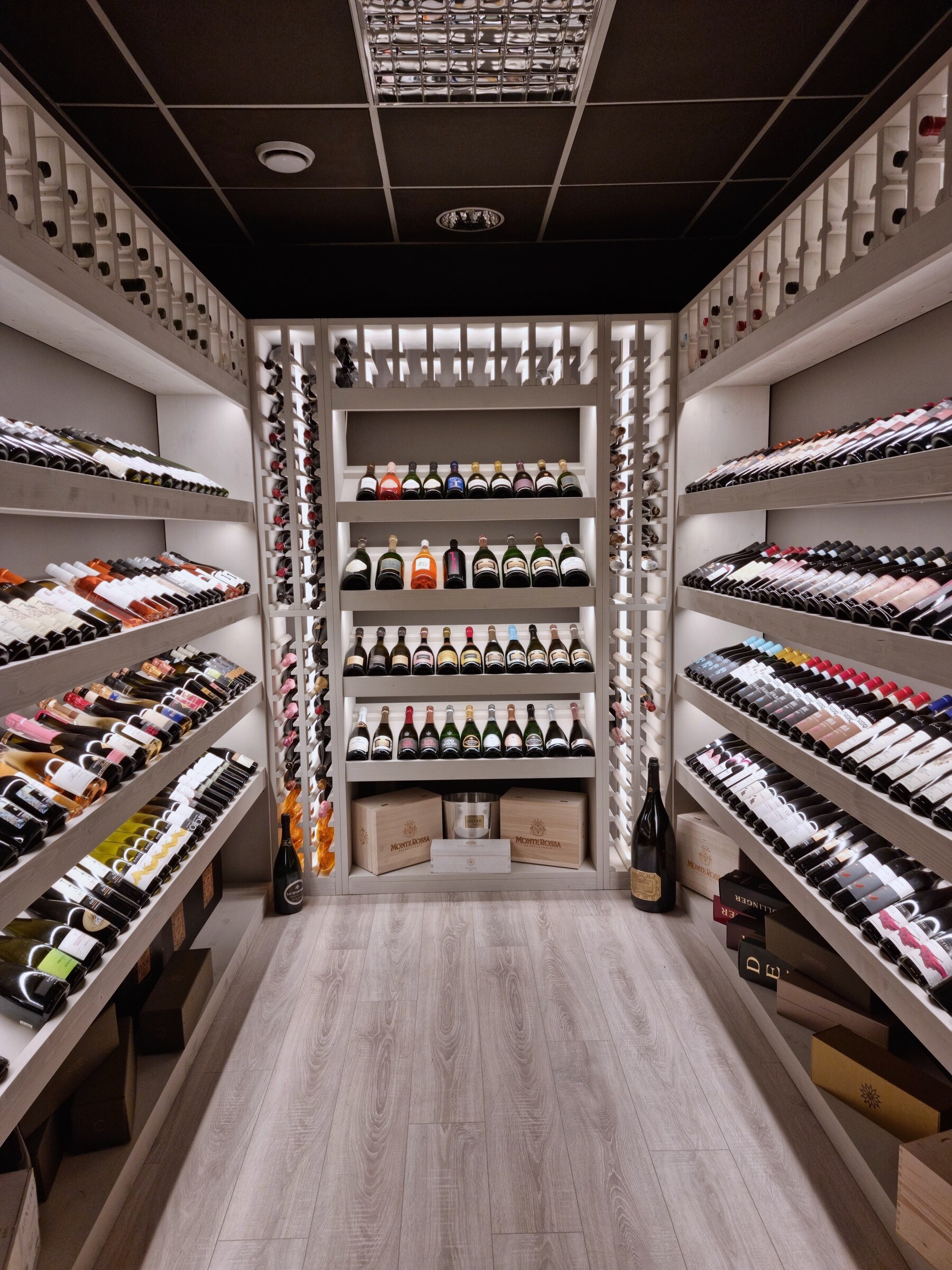 La cantina climatizzata di MineralBirra a Parma, con le bottiglie di vino in scaffalatura